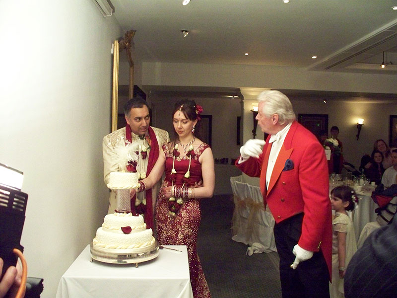 Toastmaster Assisting Cutting of Cake at Indian Wedding